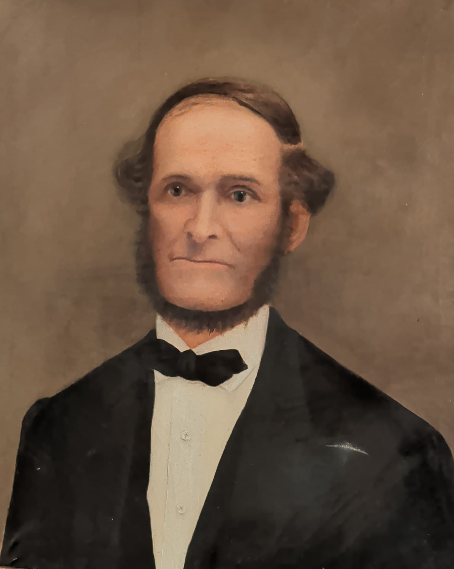 Oil portrait of Clark Maine of Hermon: a man with side whiskers, a white shirt, black tie and black coat.
